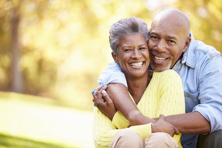 Senior Couple Relaxing In Autumn Landscape